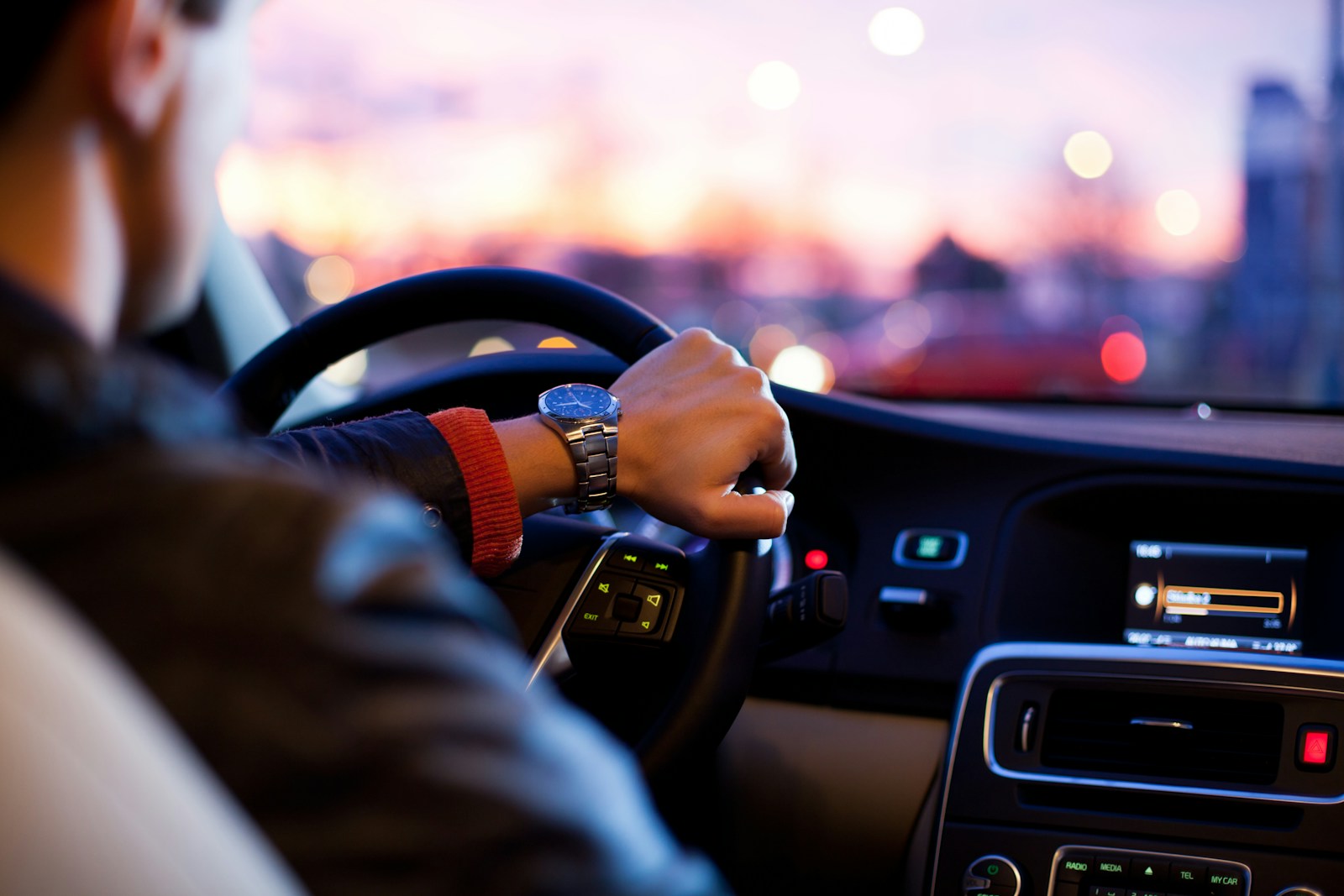 man driving a car wearing wrist watch, auto